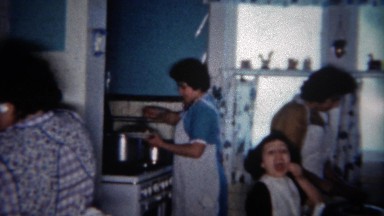 1963: Family eating bowls of food together at kitchen table. BUFFALO, NEW YORK