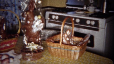 1963: Easter baskets on kitchen table with giant chocolate candy rabbit.