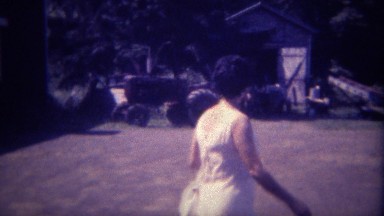 1963: Modern urban women visits her childhood tractor farm. DES MOINES, IOWA