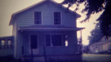 1971: American farmhouse with 3 vehicles parked in the driveway. DES MOINES,