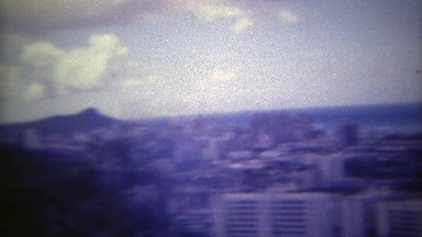 1973: Diamond Head mountain downtown hotel laden ocean beach basin. HONOLULU,