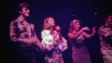 1973: Embarrassed drunk tourists learning hula dancing rope spinning on stage.