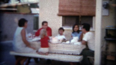 1966: Family enjoying the backyard patio picnic table with lunch. SAN DIEGO,