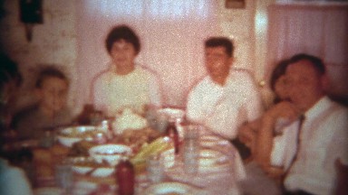 1966: Family crowded into a small kitchen table for a holiday feast to remember.
