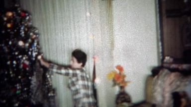 1966: Women gets fur coat gift for Christmas models in front of tree. BUFFALO,