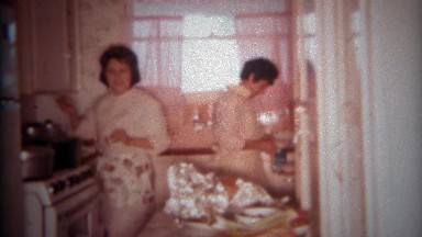 1966: American family celebrates thanksgiving in the kitchen and watching tv.