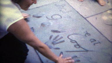 1965: Women visits walk of fame actor handprints of Gary Cooper. HOLLYWOOD,
