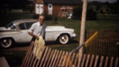 1964: Grandpa arrives in new white sports car to pool party. BUFFALO, NEW YORK