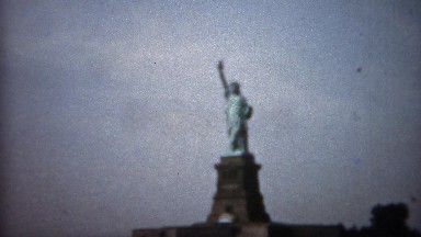 1961: Statue of Liberty closeup tilt up and far shot. New York City