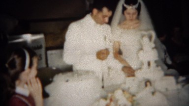 1966: Cute bride and groom wedding cake feeding session. BUFFALO, NEW YORK