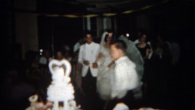 1966: Crowd following wedding couple around reception hall. BUFFALO, NEW YORK