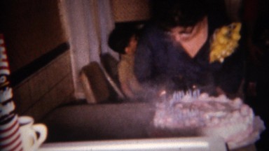 1959: Lady Blows Out Birthday Cake with Smoking Candles in Buffalo, New York