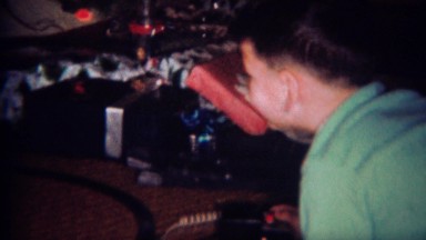 1961: Boy controls toy train set at Christmas time. GREELEY, COLORADO