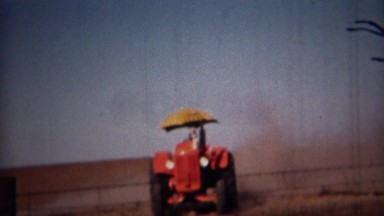 1951: John Deere umbrella tractor grading the fields. LINCOLN, NEBRASKA