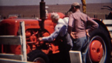 1951: Salesman sells man new red Case brand farm tractor. LINCOLN, NEBRASKA