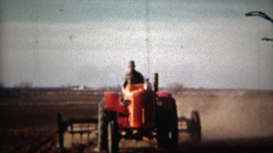 1951: Red Tractor Plowing Farm Fields in Lincoln, Nebraska