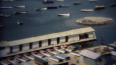 1948: Boats in the harbor at the water level dropping desert reservoir. LAKE