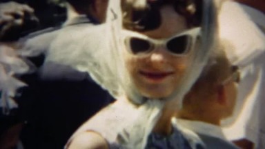 1966: Early 60's Style Woman in White Sunglasses and Headscarf, Denver