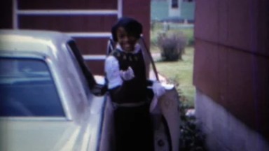 1967: African American Girl Blows Kiss to Camera as She Enters Car in Carmel, Indiana