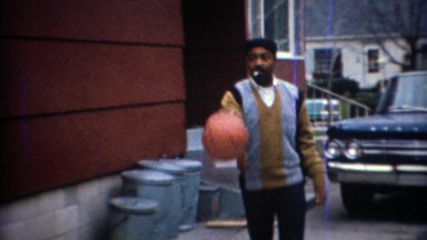 1967: African American formal sweater basketball man in driveway. CARMEL,