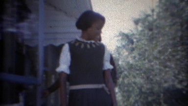 1967: African American mother and daughter formally dressed with wacky yellow
