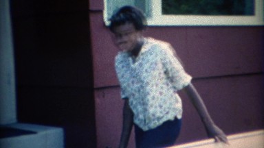 1967: African American family being silly as they leave the family car. CARMEL,