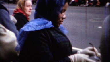 1967: African American mom front row on parade route. CHICAGO, ILLINOIS