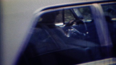 1967: White Early 1960s Lincoln Car Pulling Out of Driveway in Carmel, Indiana