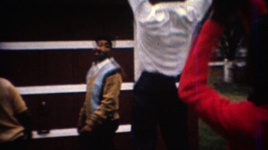 1967: Adult men playing basketball in backyard driveway court. CARMEL, INDIANA