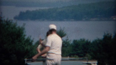 1969: Dad teaching son table tennis at scenic outdoor location. CAPE COD, MASS.