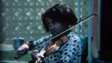 1967: African American teenager practicing classical violin music. CARMEL,