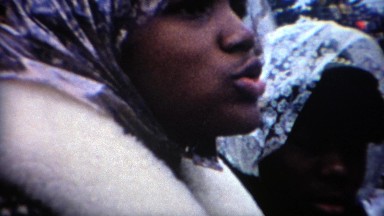 1969: Outdoor stadium sports fan cover up during cold wet weather. WEST