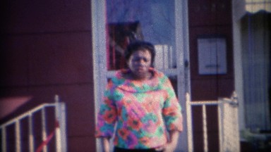 1969: Women colorful psychedelic style fashion blouse in front yard. CARMEL,