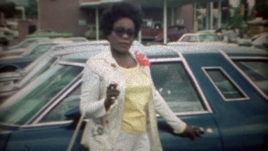 1969: Afro Hairstyle African Woman Posing by Car in Bank Parking Lot