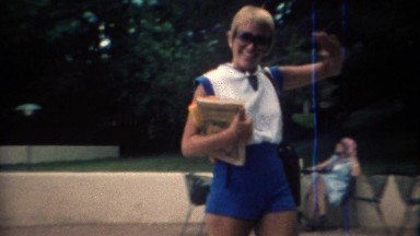 1969: Pixie haircut partner arrives for lunch at outdoor dining area.