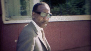 1969: Cool Formal Dressed African Man Opening Car Door