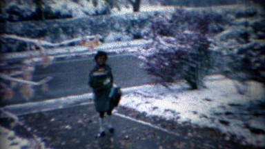 1968: African girl coming home from school on snow day.