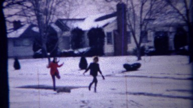 1971: Multicultural Girl Friends Running on Winter Snow Day in Carmel, Indiana