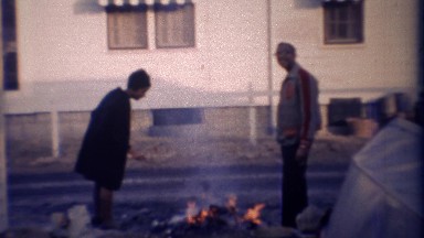 1971: Backyard fire surprises neighbor opening back door.