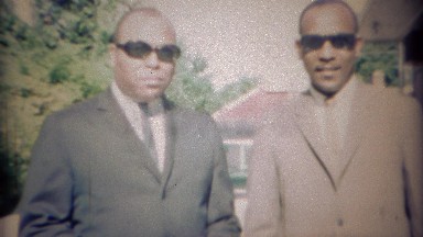 1969: African Men in Suits and Sunglasses Enter Long White Lincoln Car