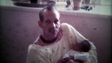 1979: Dad Gently Rocking Newborn Baby Girl in Hospital Gown