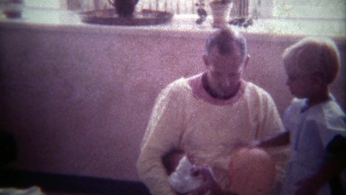 1978: Dad Showing New Baby to Blonde Haired Toddler Son.
