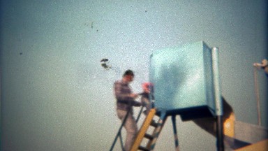 1979: Father and son go down twisted metal slide together.