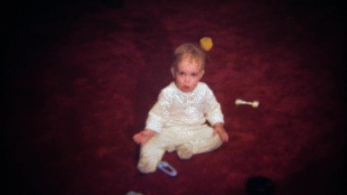 1979: Crying baby crawls away hiding behind living room couch.