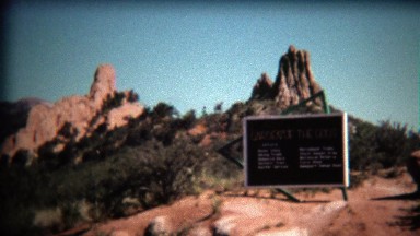 1972: Garden of the Gods park entrance sign on bright blue day.