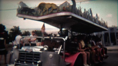 1972: People riding the zoo people mover motorized open air car bus.