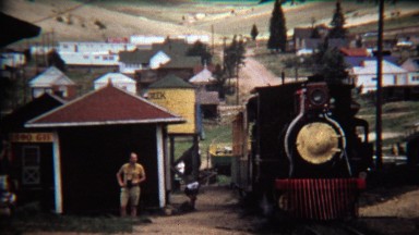 1972: Train pulling into station at old western town stop.