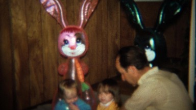 1974: Grandpa plays with blow up Easter bunny dolls and kids.