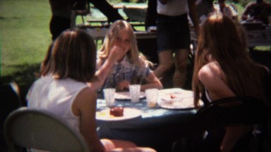 1973: Teenagers shy around dad's camera at summer family reunion.