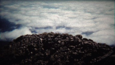 1972: Timelapse of clouds moving below high mountain summit peak.